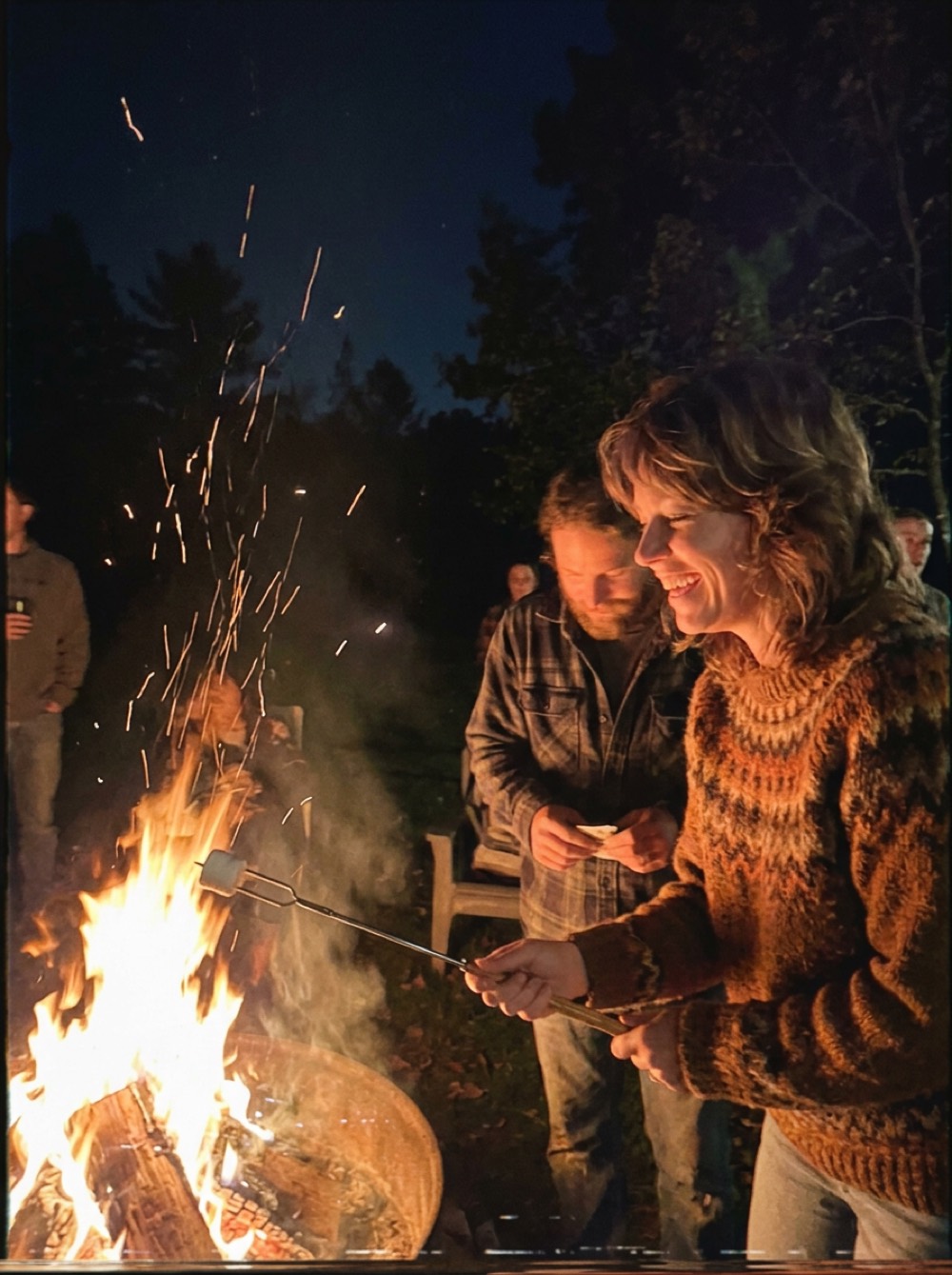 Faces lit by an autumn bonfire